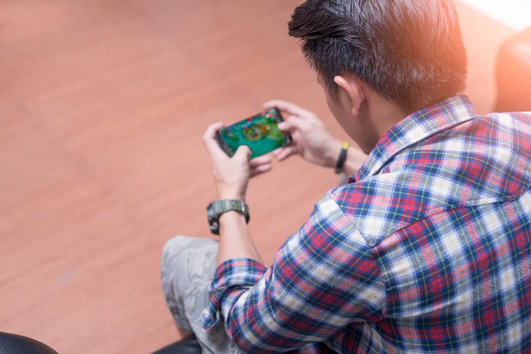 Man Playing Mobile App Game