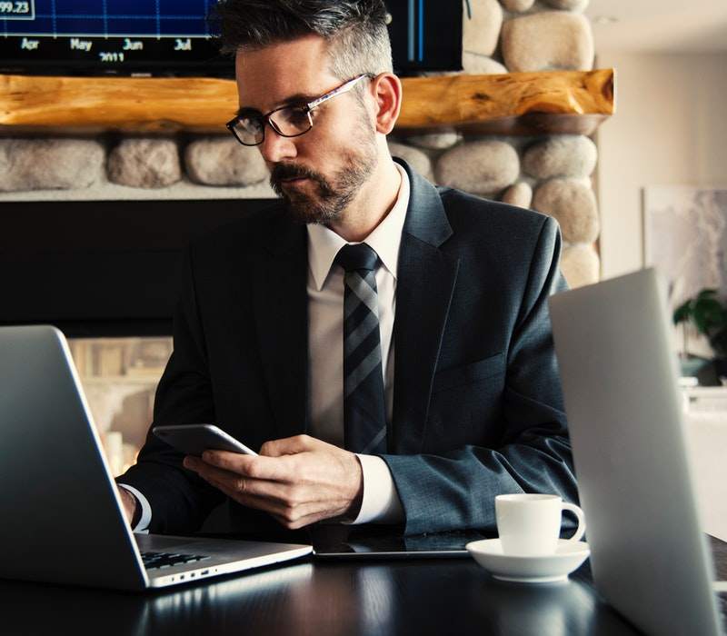 man in black holding phone