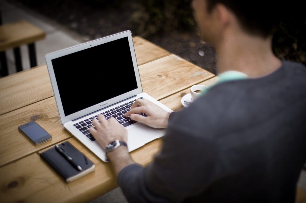 Man working on laptop and his LinkedIn marketing strategies