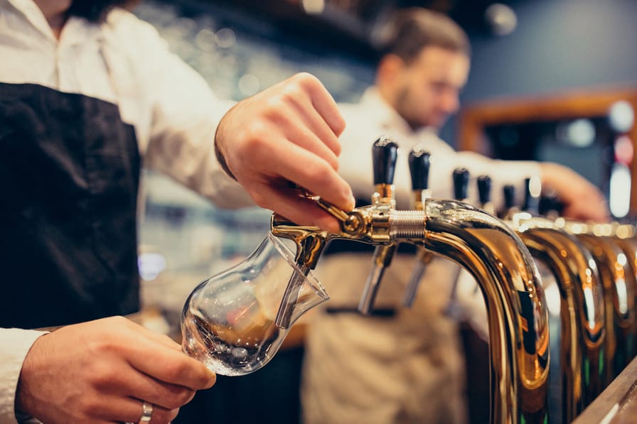 Men Poring Draft Beers On Tap