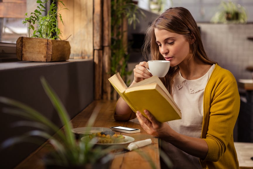 Casual Woman Reading Book Drinking Coffee