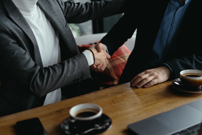 Closing the Deal Businessmen Shaking Hands Contract Signed Coffee