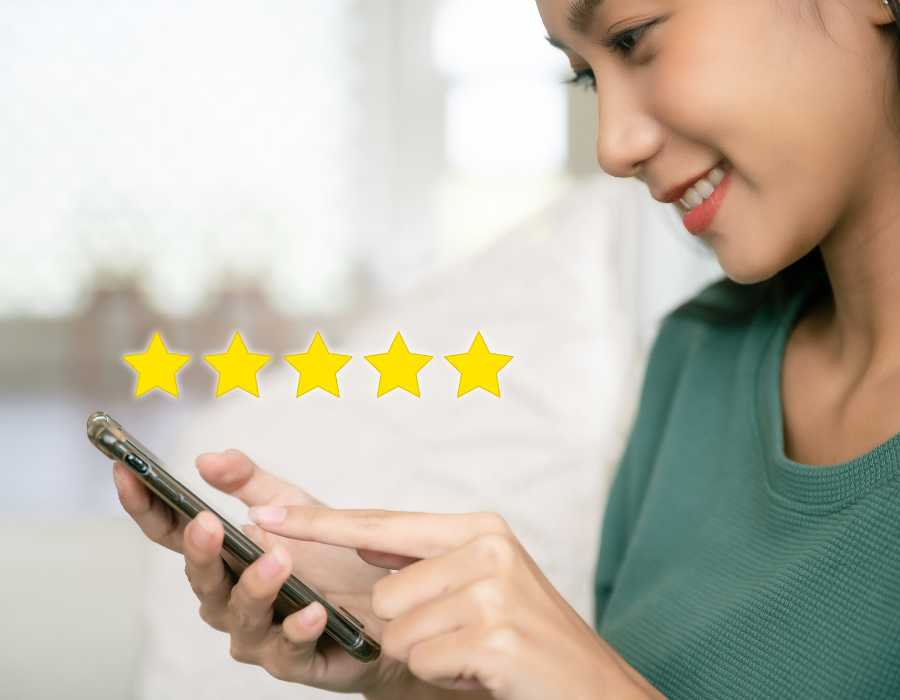 Customer Rating Woman Smiling while Looking at her Cellphone
