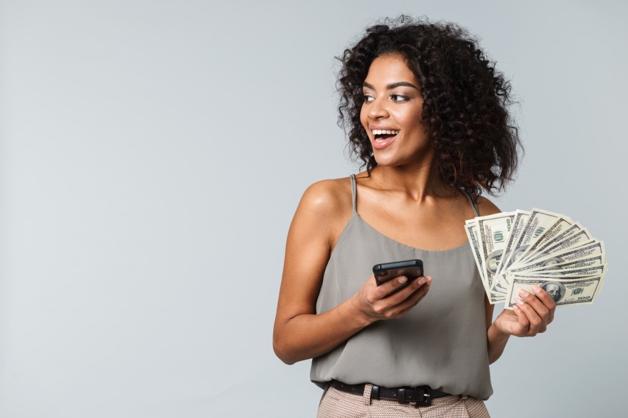 Financial Gain Woman Female Holding Dollar Bills Smartphone Happy Face Smile Smiling