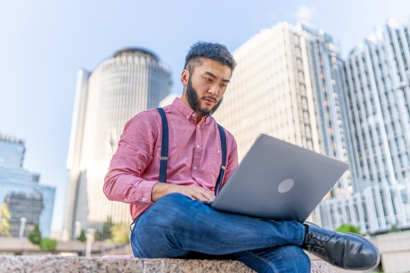 Asian Chinese Man Male Working Laptop Knees Outside Outdoors China