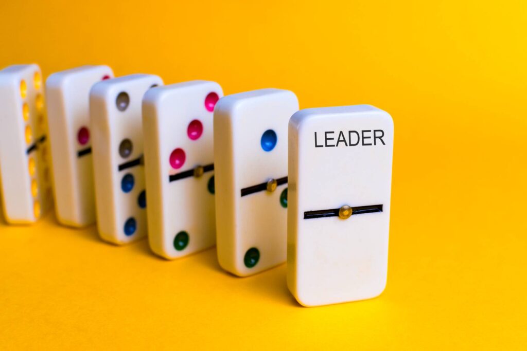 Leadership Concept. Dominoes That Follow A Chip With The Word Leader.