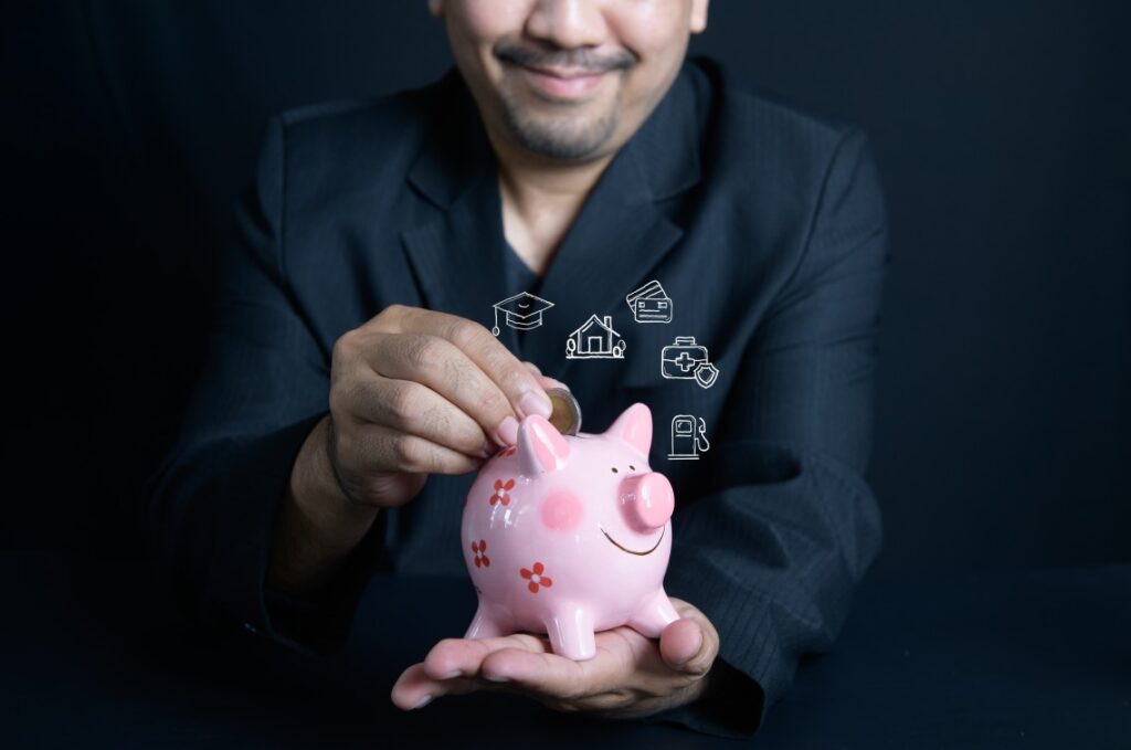 Putting Money Coin Into Piggybank Business Savings