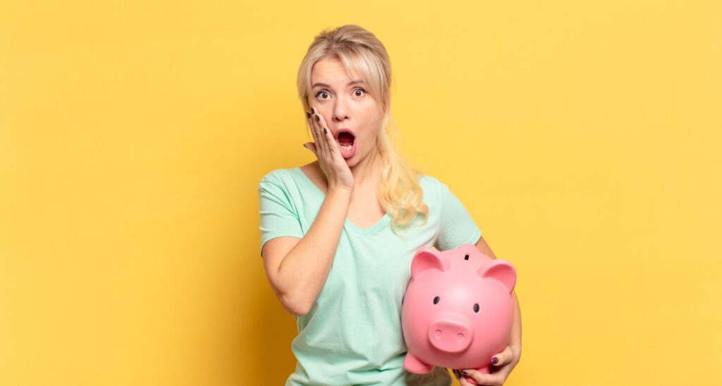 Woman Holding Piggy Bank, Yellow Background Saving Money Budgeting