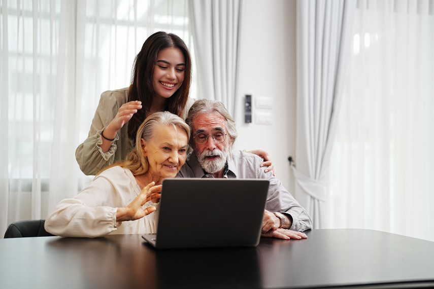 Train Personnel Staff Young Happy Smiling Woman Assisting Senior Couple Laptop