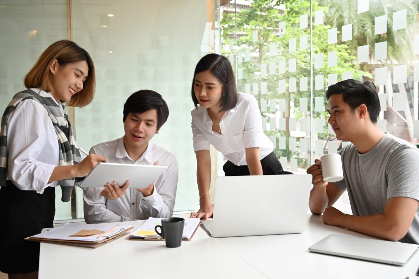 Young Business Entrepreneurs Office Laptops Communicating Communication Teamwork