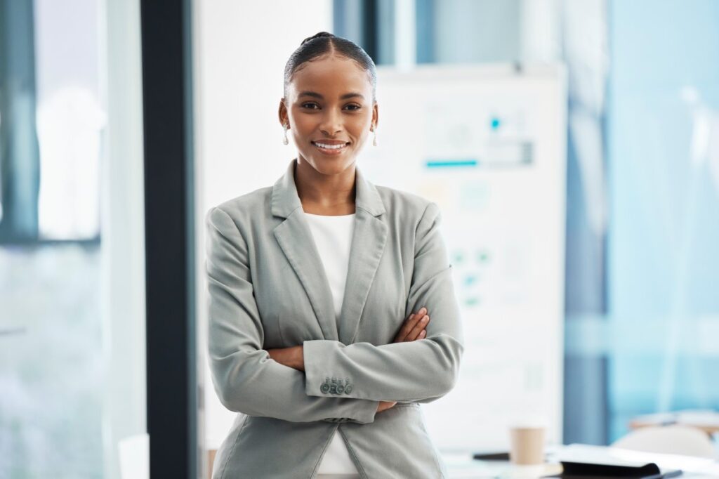 A professional, corporate leader with arms crossed