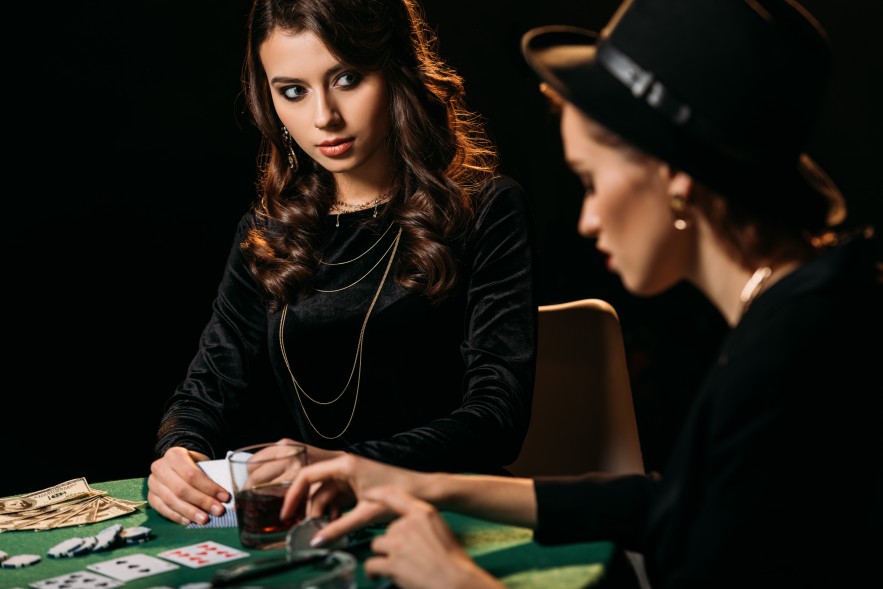 Beautiful Attractive Women Playing Texas Hold'Em Poker Card Game Casino