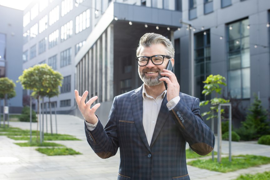 Businessman Expertise Experience Mature Man Male Successful Outside on the Phone Happy Smiling