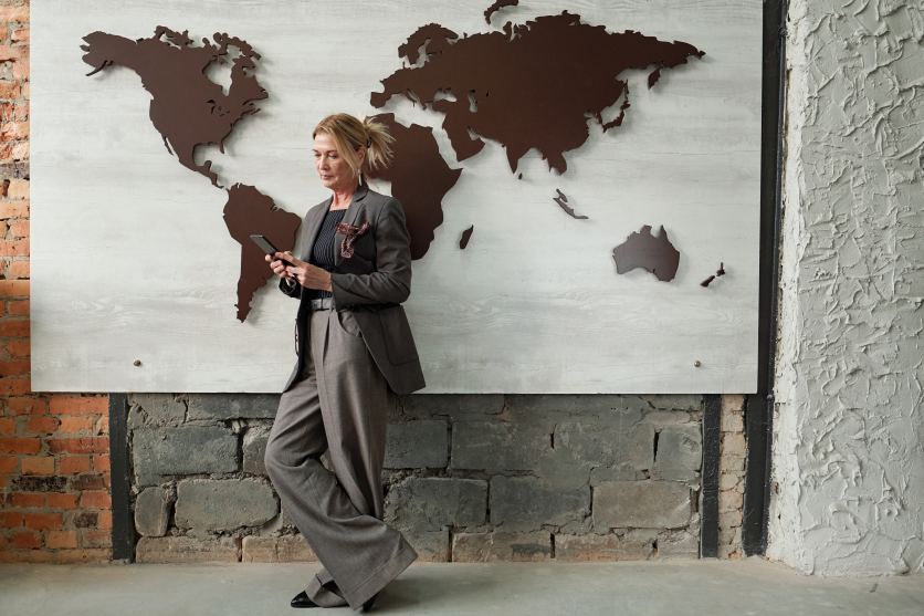 International Business Woman Female Entrepreneur Manager Standing in Front of World Map Global