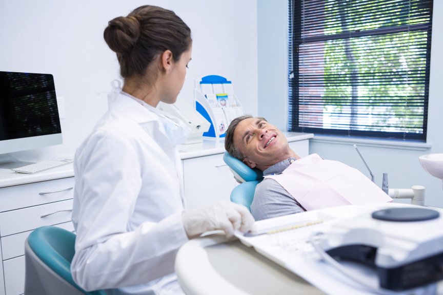 Patient Speaking Discussing with Dentist Dental Practice Chair Laid Down