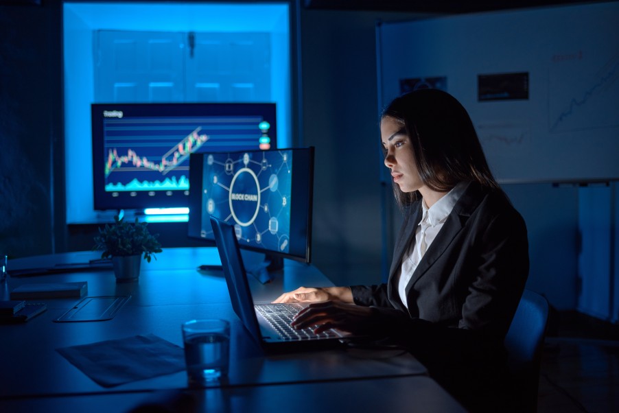 Serious Female Woman Employee Tracking Analyzing Data Analytics Computers Dark