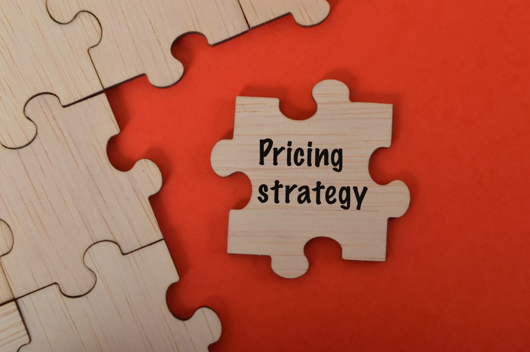 The word Pricing Strategy is written on jigsaw puzzle
