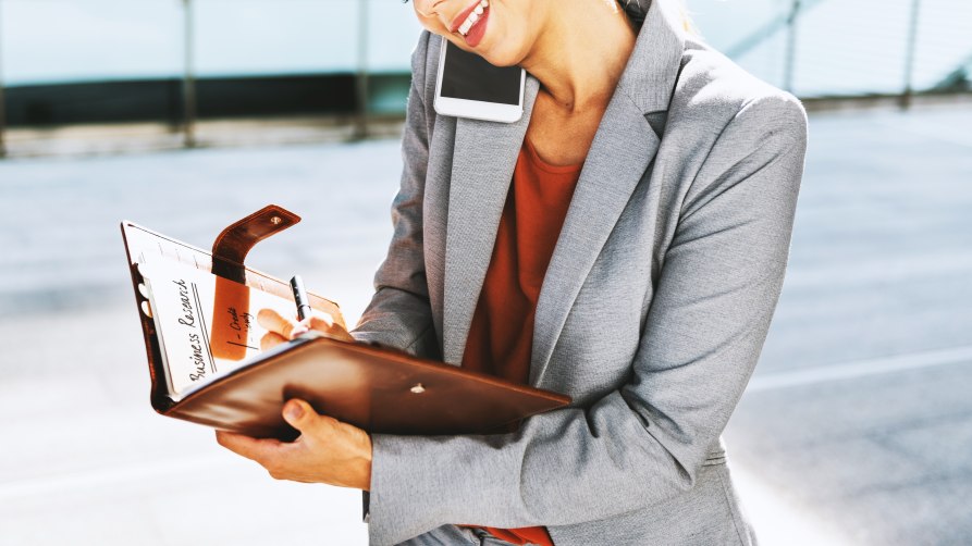 Multitasking Businesswoman Formal Professional Business Female Taking Notes Smartphone Call