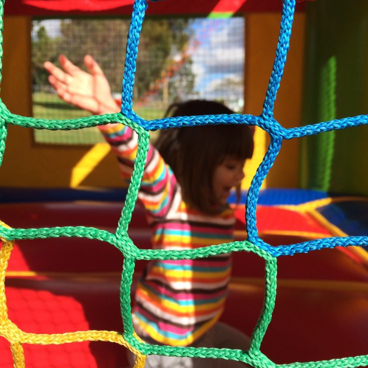 Little Girl Bounce House Holding Rope Security