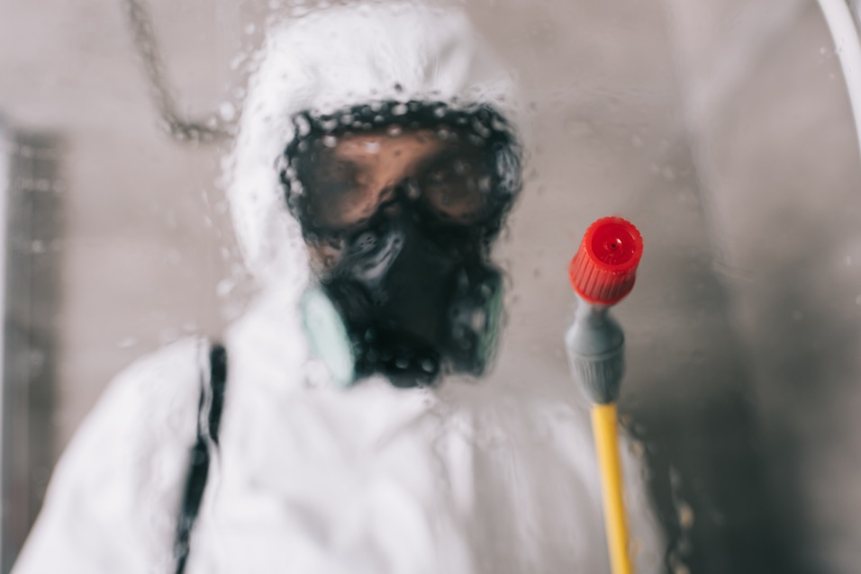 Pest Control Worker Spraying Glass Blurry Chemical Protective Suit