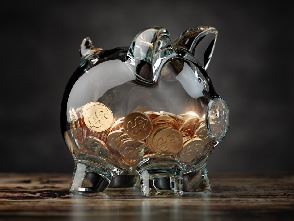 Piggy bank with golden coins containing investment for dropshipping business