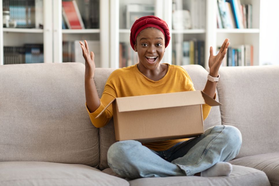 Woman unpacking parcel at home