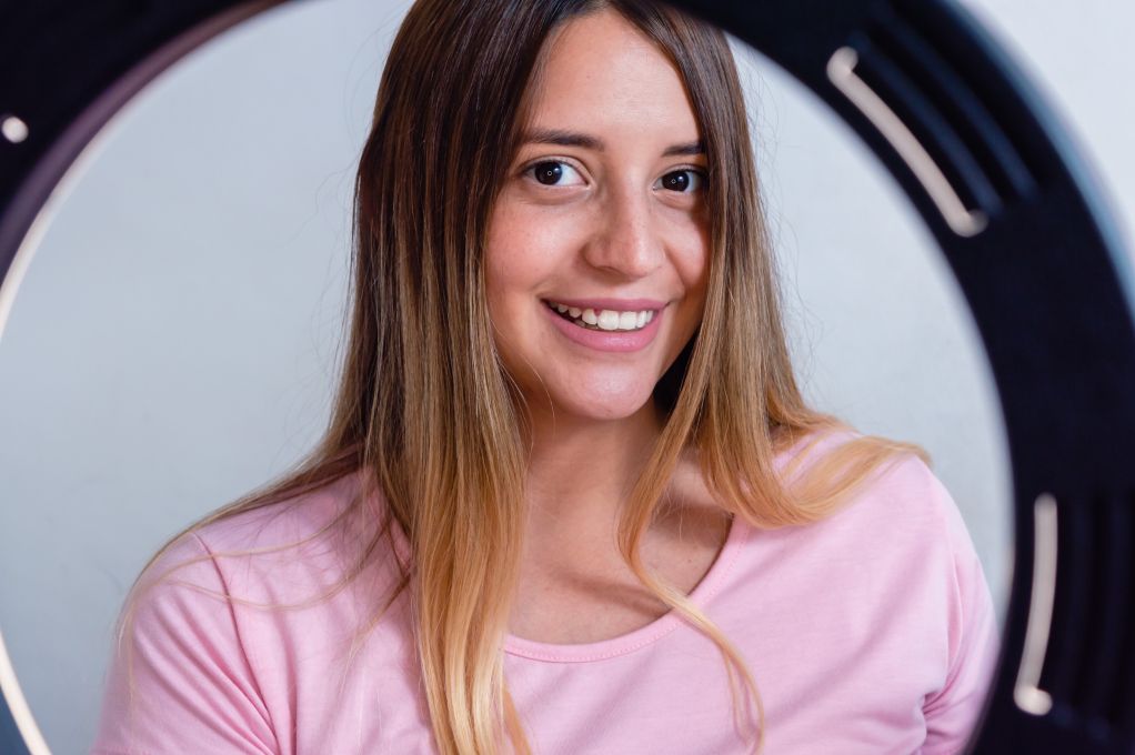 Portrait of a young woman influencer through a ring light