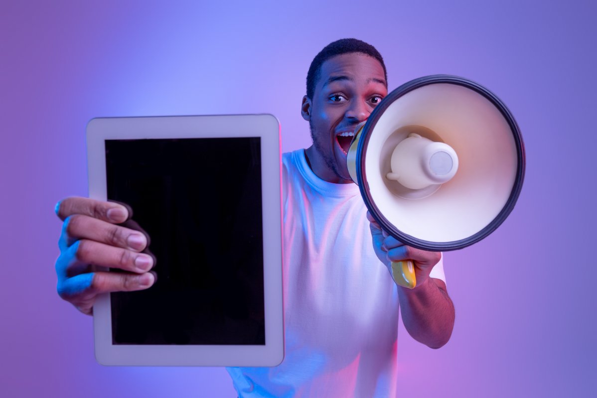 Guy With Loudspeaker Holding Digital Tablet for paid advertising
