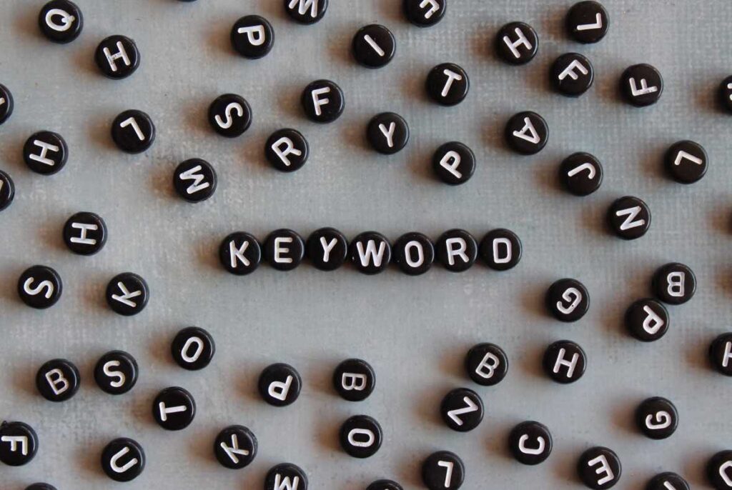 Keyword research depicted by alphabet beads with text KEYWORD