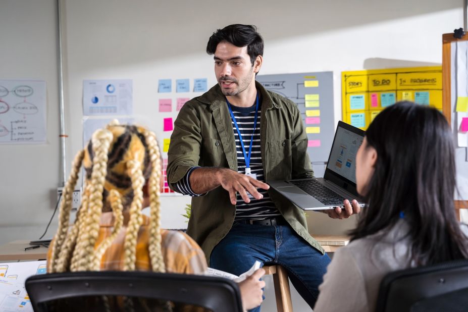 Man talking with creative designers to present his UIUX proposal to the team