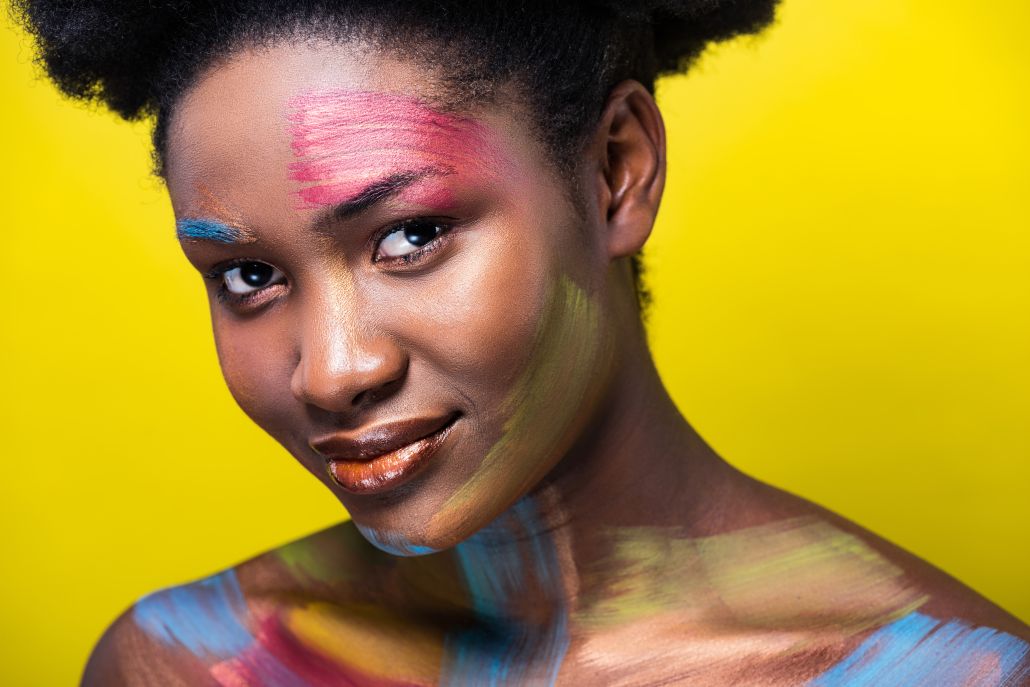 Smiling woman with bright makeup looking at camera for eye-catching visuals