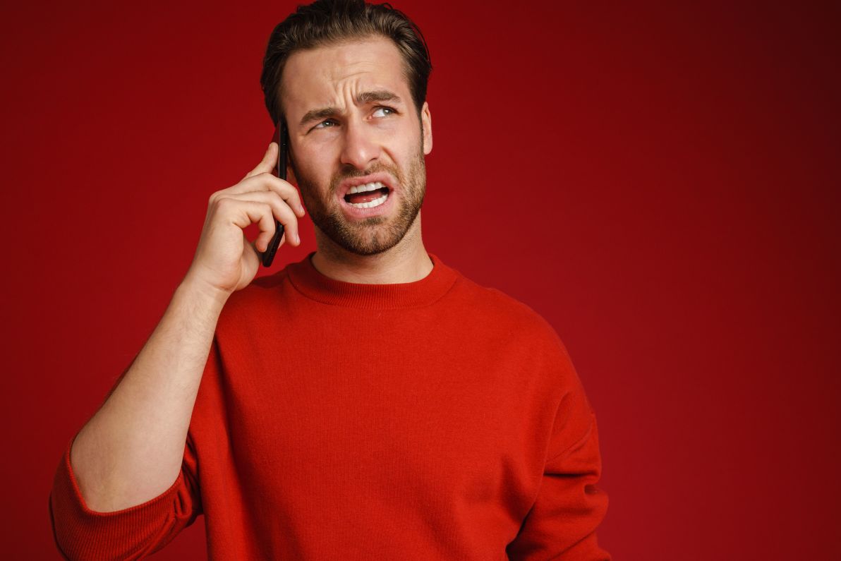 Man angry while talking on the phone and being too aggressive to close a call