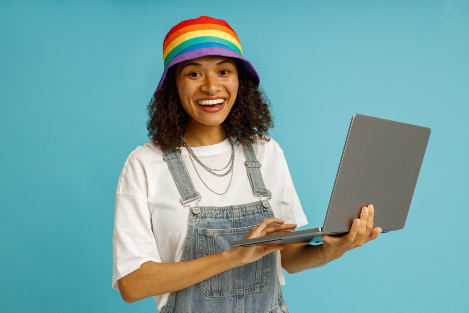 Positive Young Happy Woman Rainbow Hat Latop