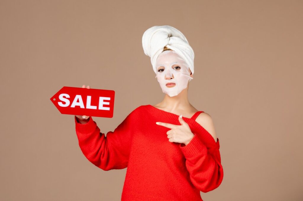 Young female with face mask holding sale nameplate