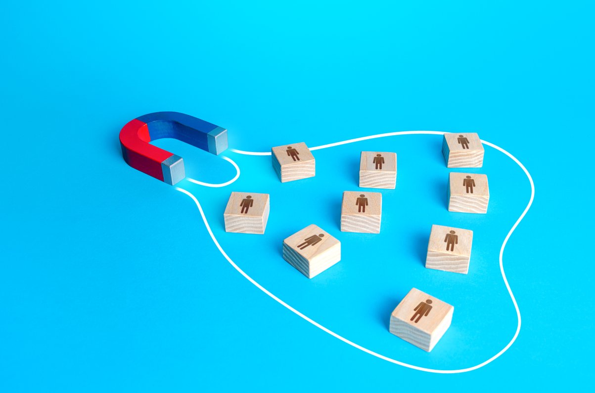 A magnet engulfing wooden blocks to represent more conversions