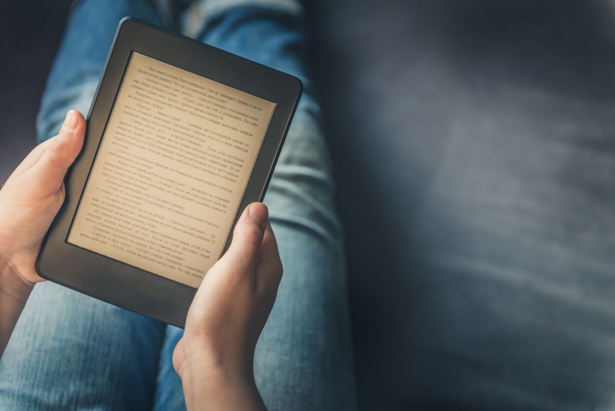 Girl is reading an ebook given as a lead magnet on digital tablet device