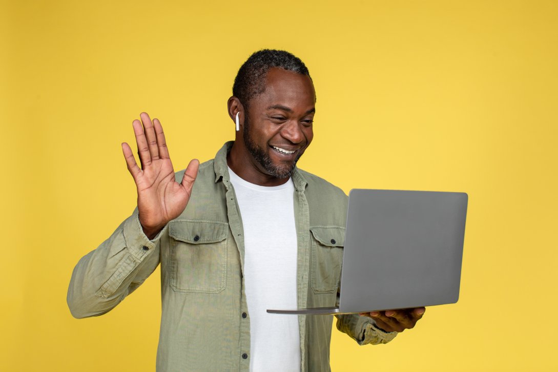 Male professional conducting a workshop while holding his laptop