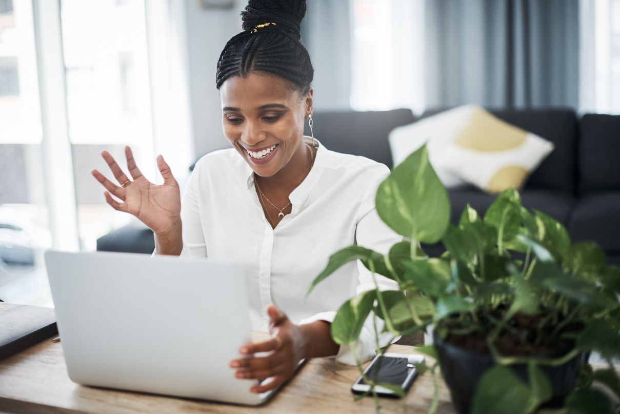 Shot of a young businesswoman sitting alone and using her laptop for remote selling