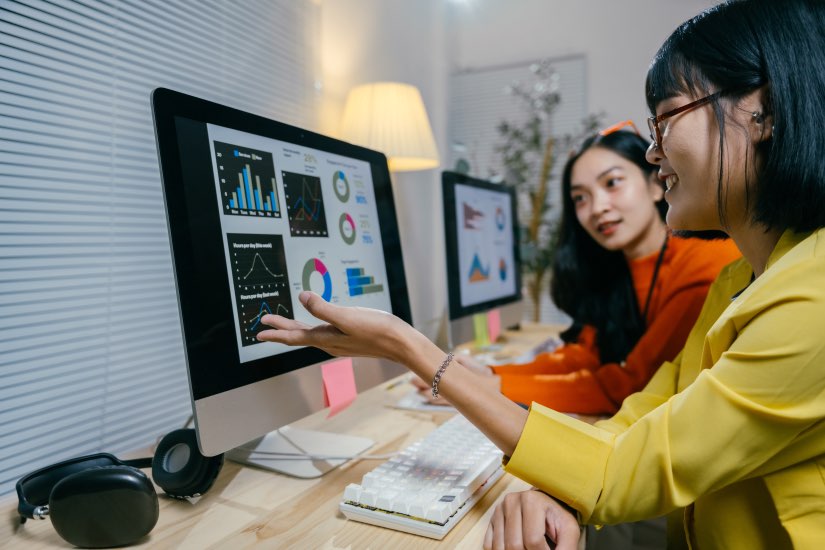 Customer Data Analytics Two Asian Women Computer Analyzing Metrics Graphs Charts