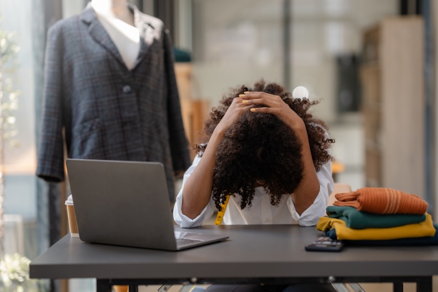 Failure to Adjust Yoing Black Woman Holding Head Desk Clothing