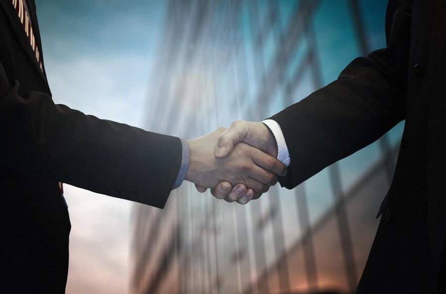 Business People Shaking Hands Signing Deal